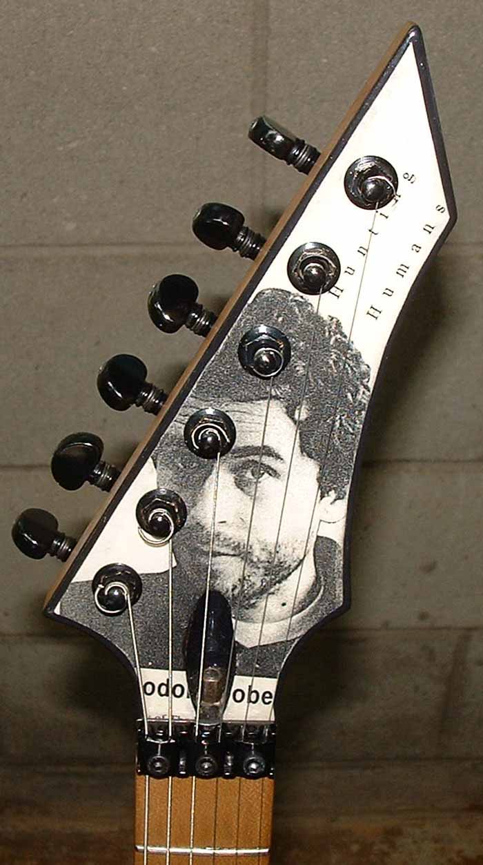 B.C. Rich Gunslinger 6 string electric guitar decoupaged with serial killer and Gray's Anatomy motif. Seymour Duncan Invader Humbucker pickup and Floyd Rose licensed locking tremelo.
